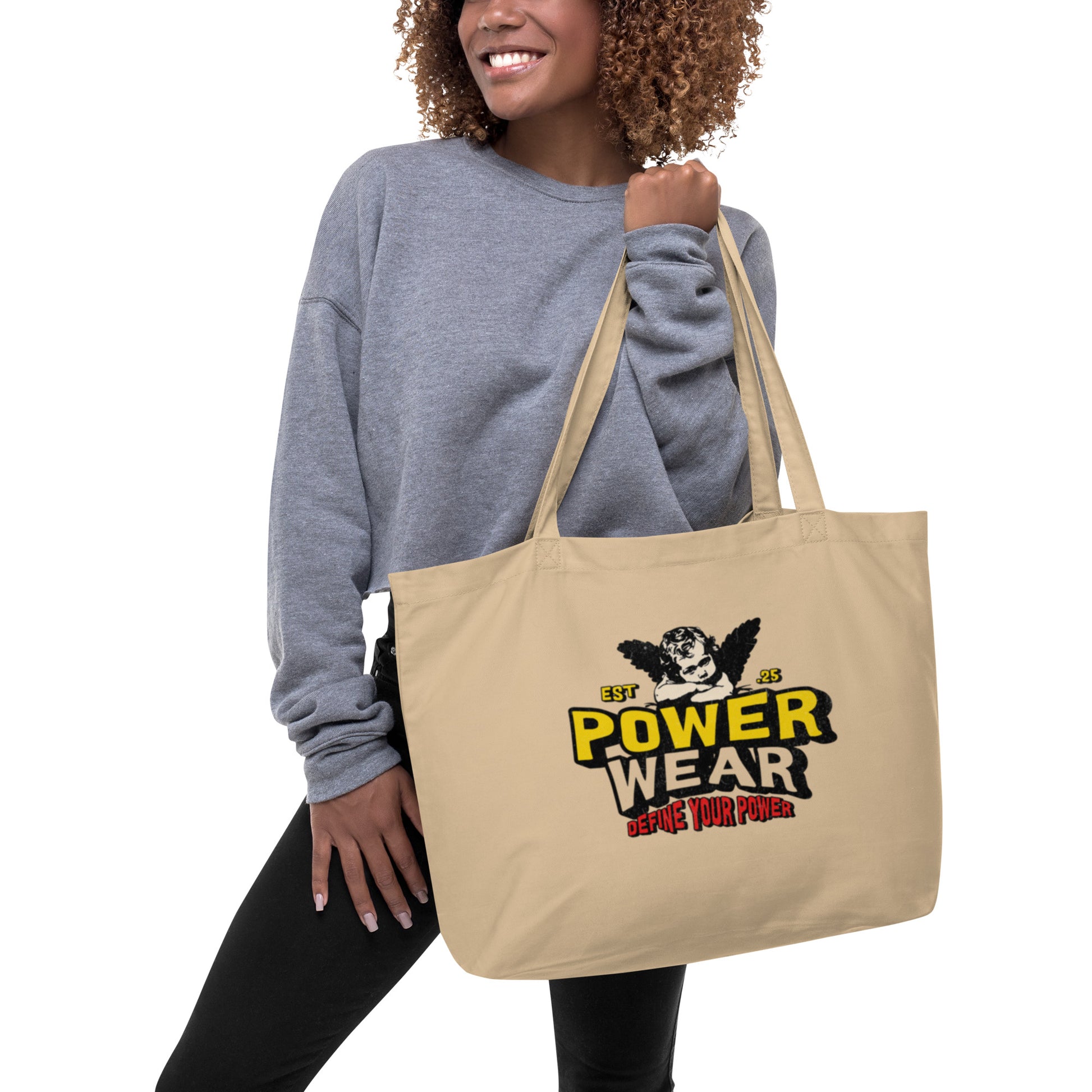 Woman holding a beige tote bag with 'Power Wear' logo
