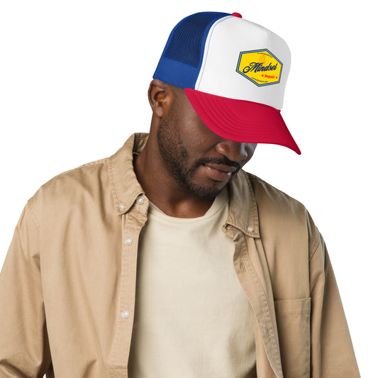 Man wearing a red, white, and blue cap with a logo on a white background